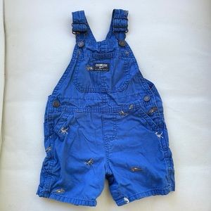Oshkosh short overalls. Blue with gray dinosaurs.